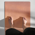 Yoga mat with peach gradient surface and grippy texture under bare feet