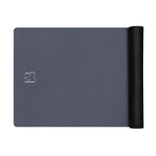 Twilight slate yoga mat with rolled black end and minimalist logo marking on surface.