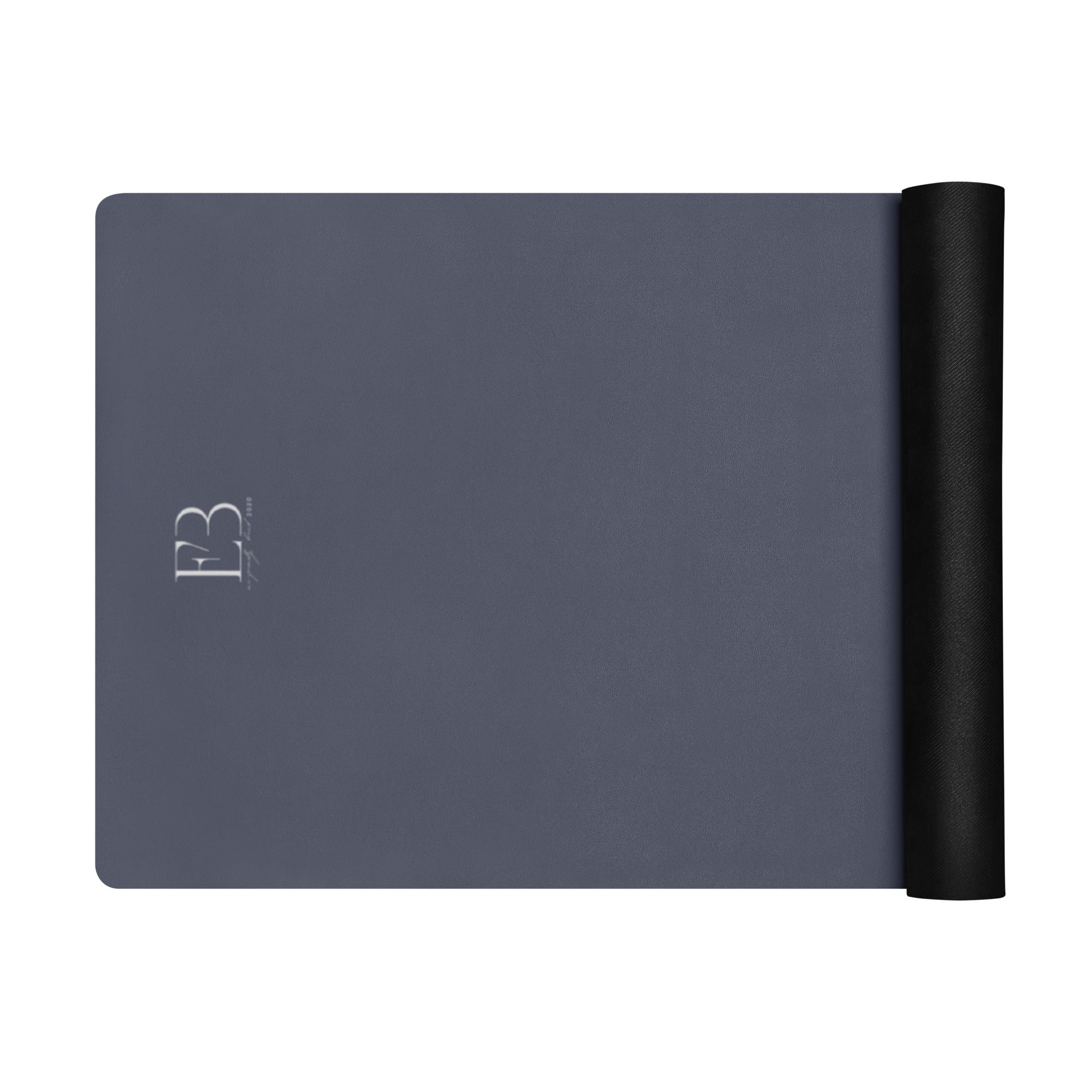Twilight slate yoga mat with rolled black end and minimalist logo marking on surface.