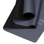 Twilight slate natural rubber yoga mat with black textured grip along the rolled edge.