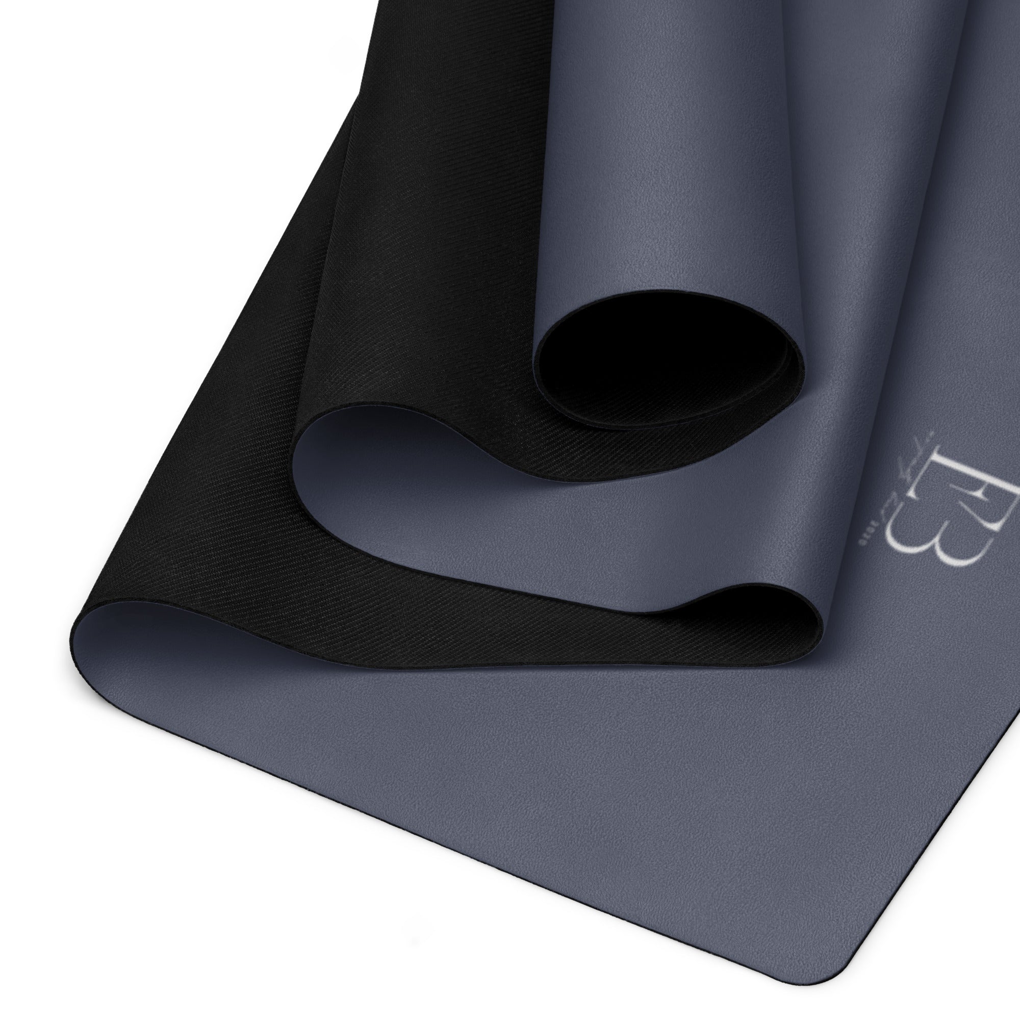 Twilight slate natural rubber yoga mat with black textured grip along the rolled edge.