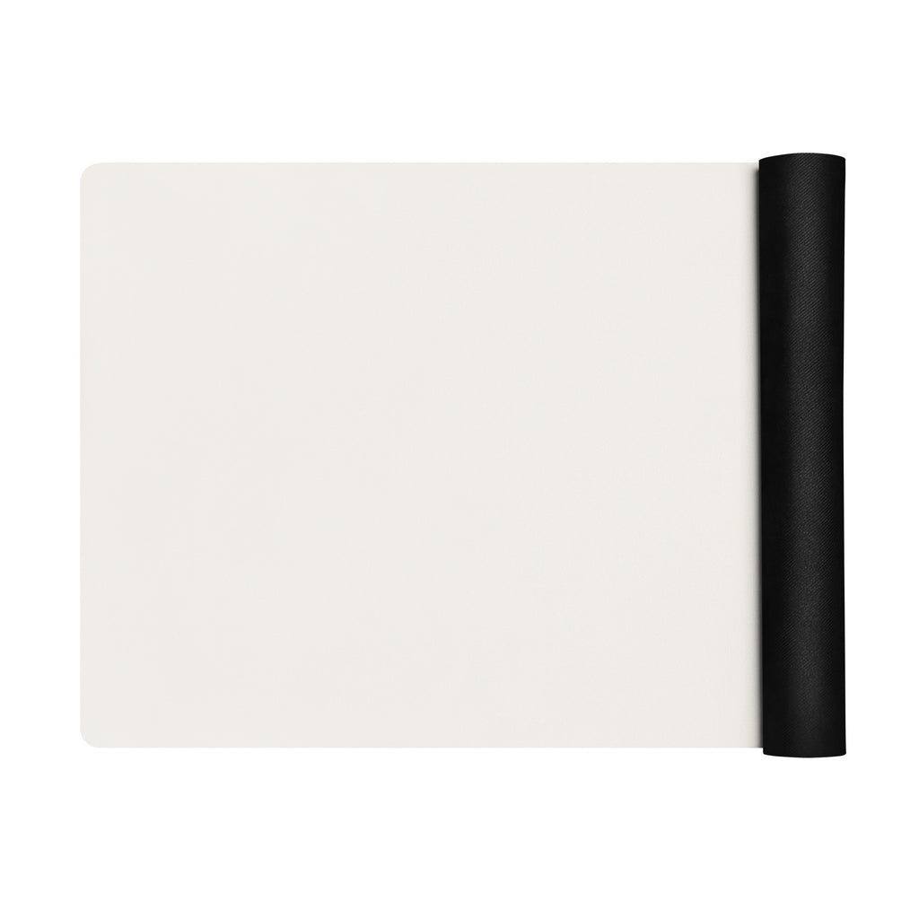 Vanilla cream yoga mat with a black rolled strap attached