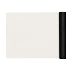 Vanilla cream yoga mat with a black rolled strap attached