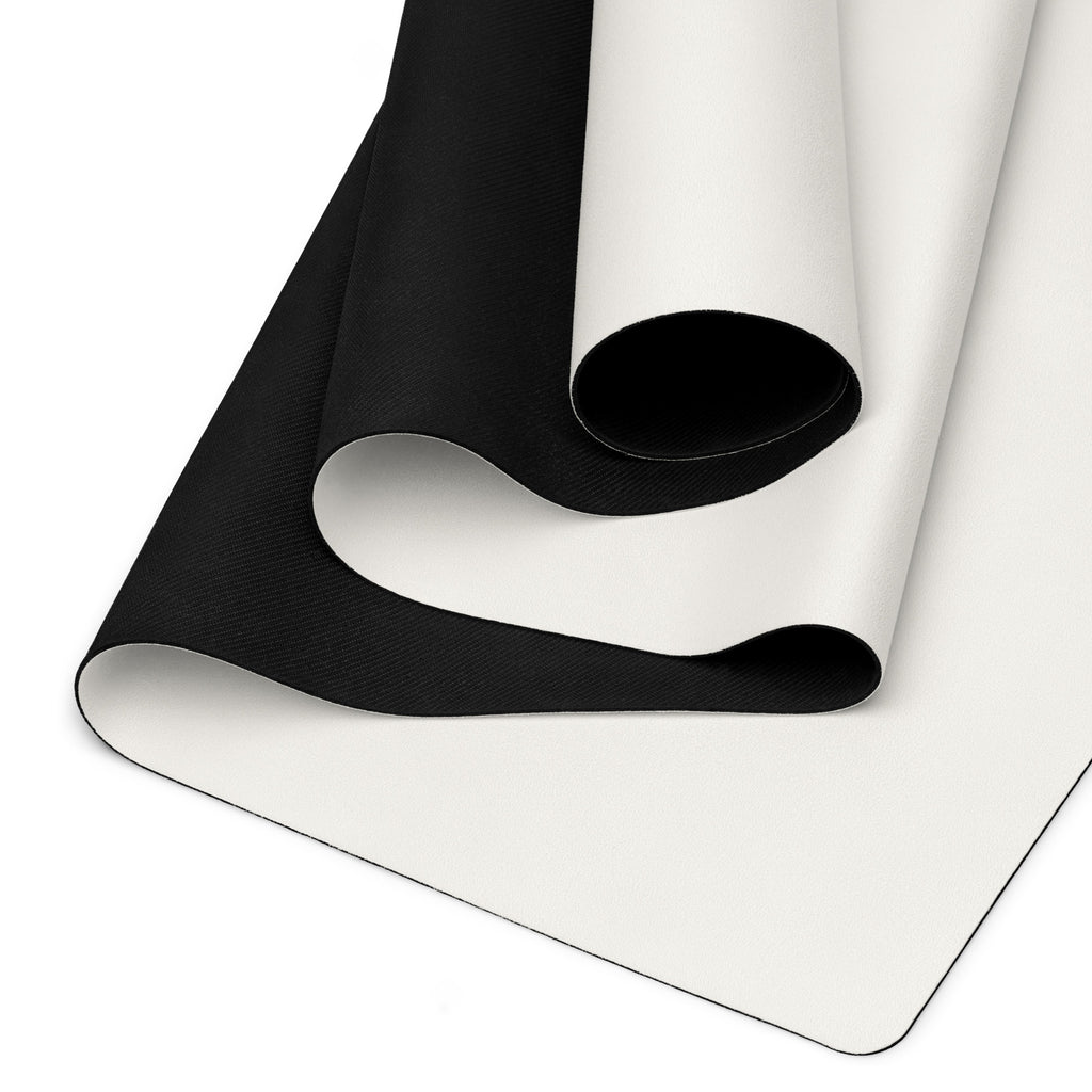 Vanilla cream yoga mat showing black textured underside and rolled edge
