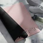 Yoga mat with mauve surface and black edge, rolled up corner detail