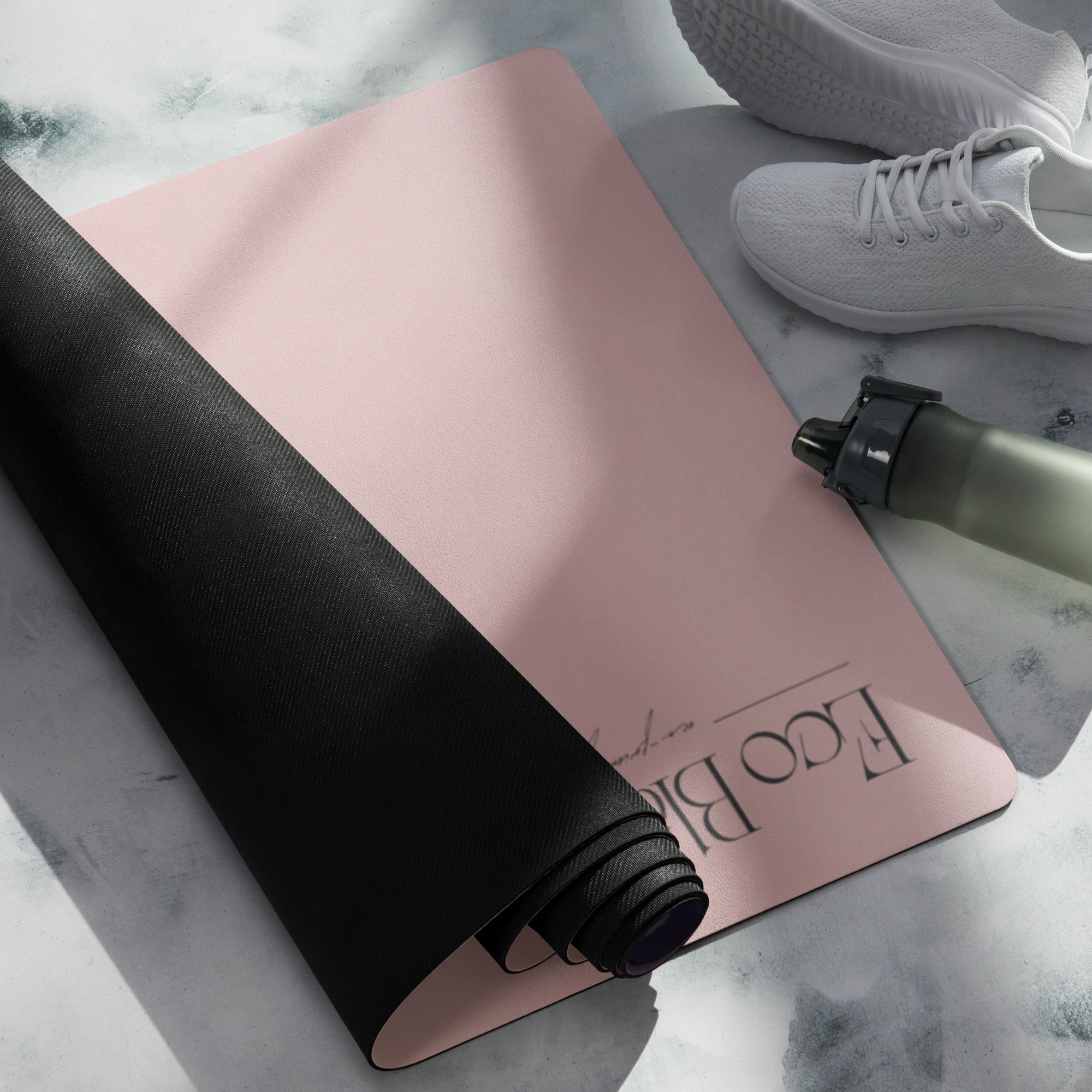Yoga mat with mauve surface and black edge, rolled up corner detail