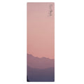 Natural rubber yoga mat with violet-pink horizon design and textured surface