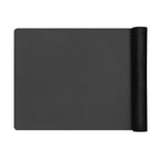 Rolled black yoga mat laid out flat, showing the rolled cylinder on one side.