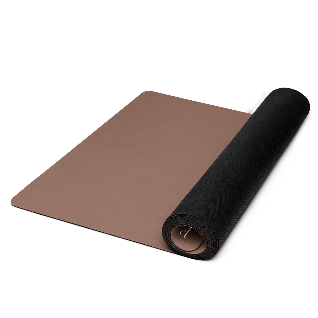 Chocolate yoga mat with rolled black end visible at the bottom