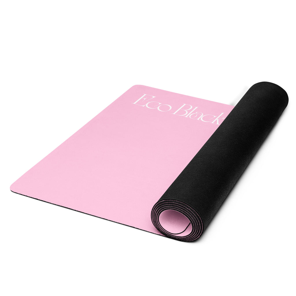 Pink yoga mat rolled with black rubber underside visible at one end