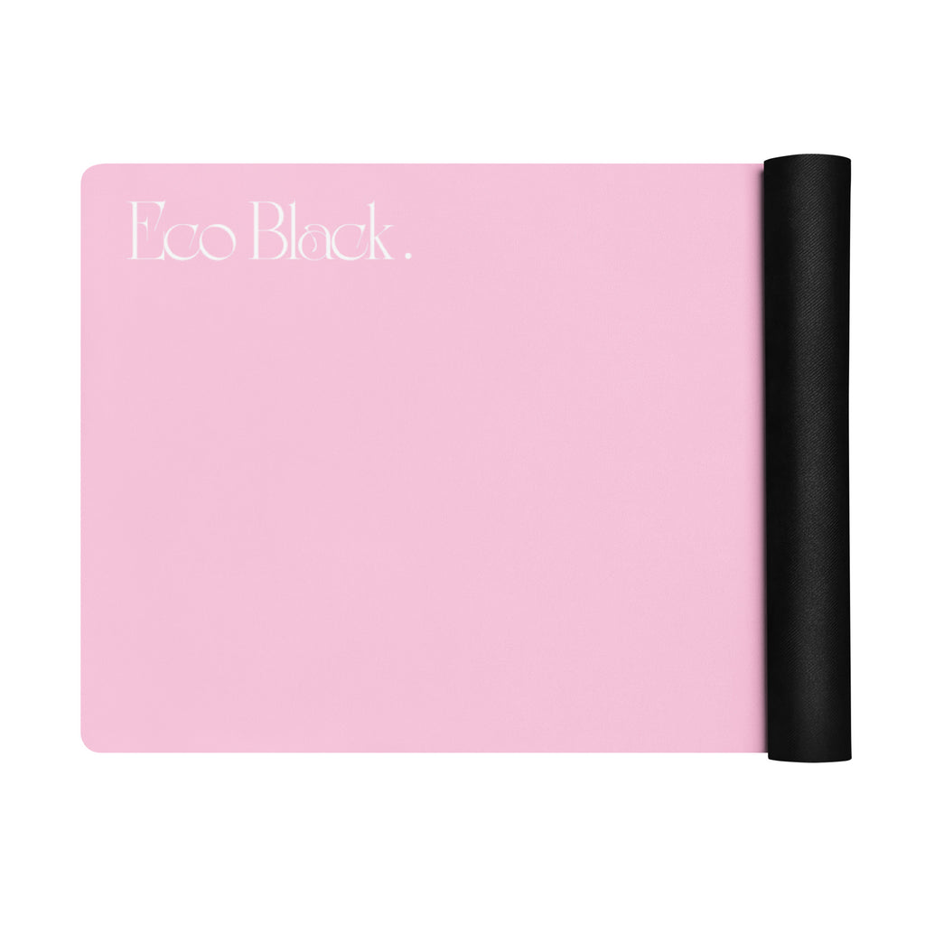 Pink yoga mat partially unrolled with black end roll on the right