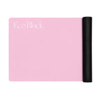 Pink yoga mat partially unrolled with black end roll on the right
