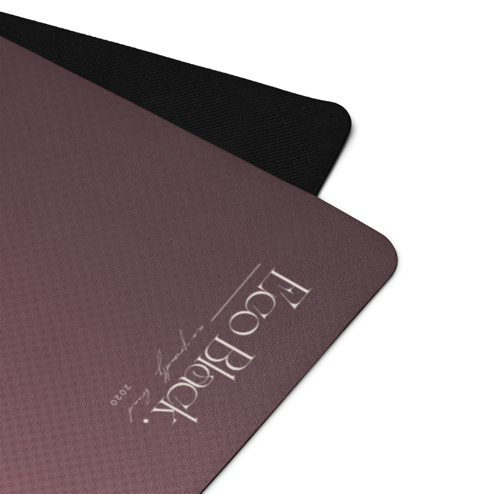 Close-up of mauve yoga mat surface with black textured border