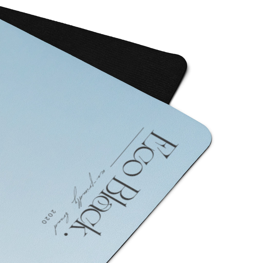 Light blue yoga mat corner with black rim and embossed logo text