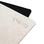 Close-up of light beige yoga mat corner with embossed brand text