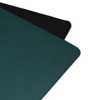 Teal yoga mat corner with textured black edge and smooth natural rubber surface