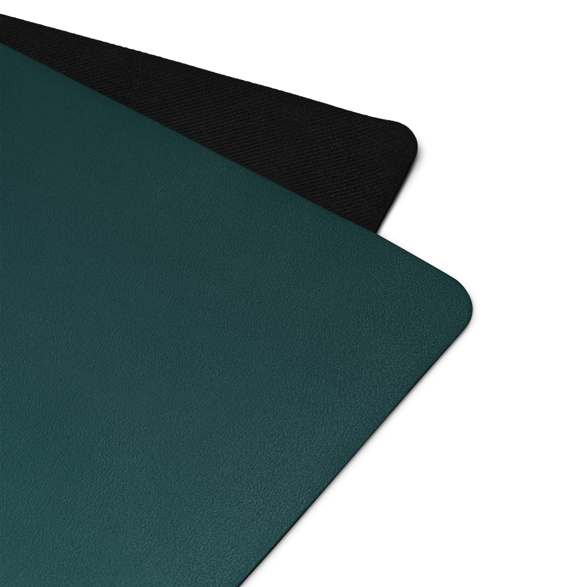 Teal yoga mat corner with textured black edge and smooth natural rubber surface