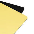 Yellow yoga mat corner with black end cap, close-up of edge.