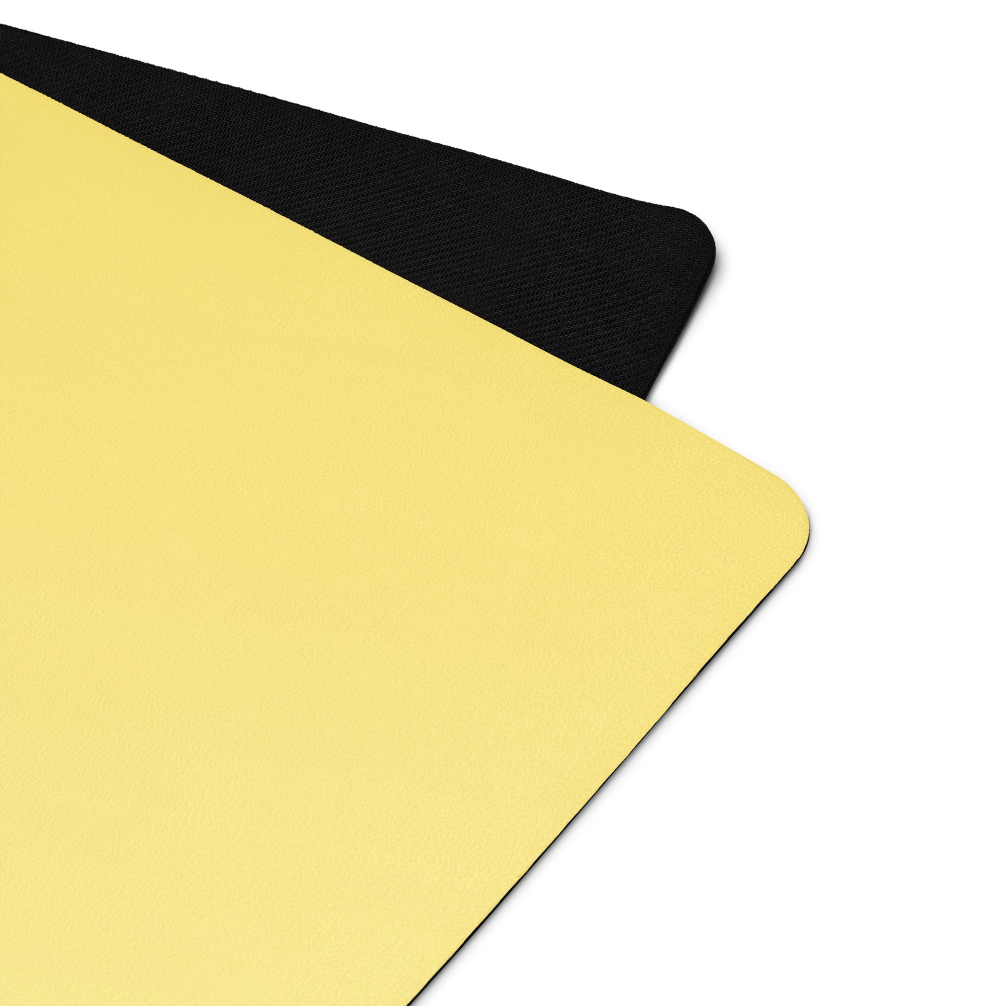 Yellow yoga mat corner with black end cap, close-up of edge.