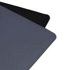 Slate blue yoga mat close-up showing textured surface and black edge binding