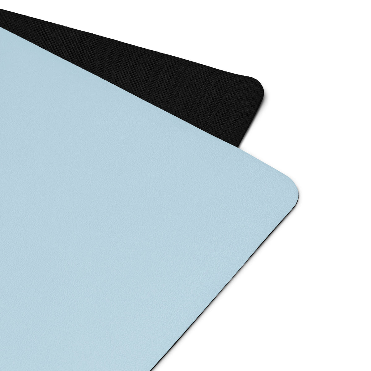 Powder blue yoga mat corner with textured black edge trim.